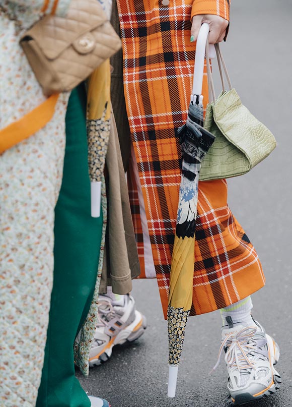 The Wool Lab: Eccentric/Bold - Orange tartan trench coat, colourful umbrella and pale green snakeskin handbag